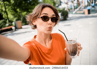 Photo of cute sweet shiny girl streaming recording instagram video drinking tasty ice latte spring sunshine outdoors - Powered by Shutterstock