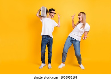 Photo of cute two persons dressed white t-shirt glasses showing v-signs listening boom box isolated yellow color background