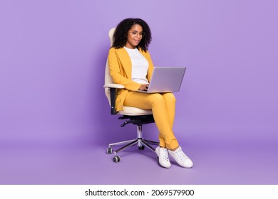 Photo of  cute woman dressed yellow suit spectacles sitting chair typing modern device isolated violet color background - Shutterstock ID 2069579900