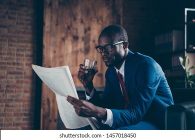 Photo of dark skin macho guy sitting office sofa drinking alcohol beverage reading fresh press wear elegant costume