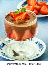 Photo of delicious chocolate mousse with strawberries 