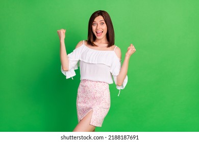 Photo of delighted astonished girl raise fists triumph luck shout yes hooray isolated on green color background - Shutterstock ID 2188187691