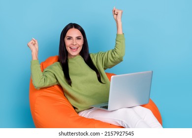 Photo of delighted positive person raise fists success achieve eshop isolated on blue color background