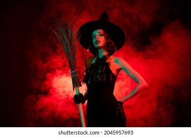 Photo of devil cruel mysterious woman wear gothic witch dress headwear holding flying broom stick isolated red fog color background