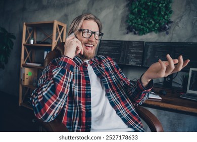 Photo of digital marketing specialist blond hair young guy sitting on armchair with smartphone having phone call indoors coworking office - Powered by Shutterstock