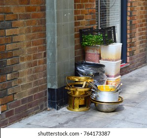 A Photo Of Dirty Dishes And Food Prep Sitting Out On The Street