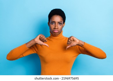 Photo Of Displeased Unisex Person Show Thumb Down Disagree Solution Wear Yellow Turtleneck Isolated Blue Color Background