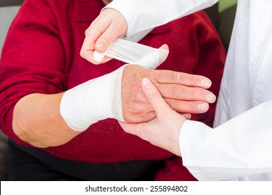 Photo of doctor bandaging the elderly woman thumb - Powered by Shutterstock