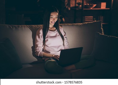 Photo of domestic chinese lady holding notebook knees texting colleagues night worker browsing crazy addicted workaholic sit comfy sofa casual clothes dark living room indoors - Shutterstock ID 1578576835