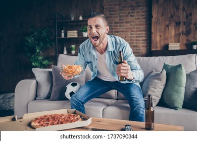 Photo Of Domestic Handsome Guy Stay Home Quarantine Time Watch Television Eat Pizza Drink Beer Sit Cozy Sofa Football Season Opening Support Favorite Team Modern Interior Living Room Indoors