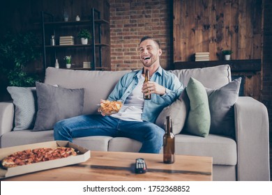 Photo Of Domestic Handsome Guy Stay Home Quarantine Time Watch Television Eat Pizza Drink Beer Sit Comfy Sofa Football Season Support Favorite Team Modern Interior Living Room Indoors