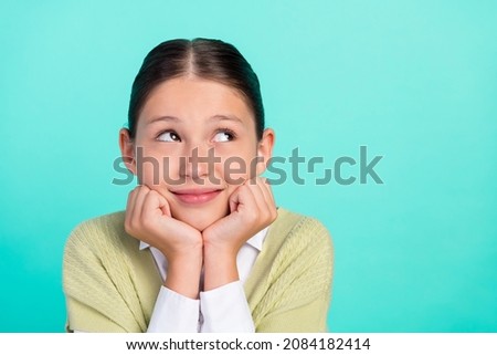 Photo of dream cheerful lady arms cheeks look empty space wear green top cardigan isolated teal color background