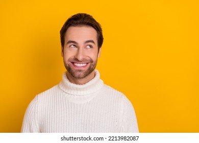 Photo Of Dreamy Charming Guy Wear White Pullover Looking Empty Space Isolated Yellow Color Background