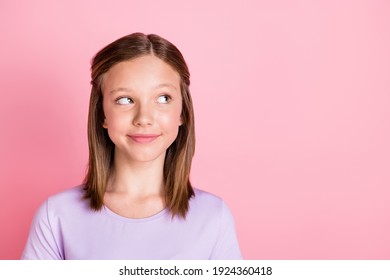 Photo of dreamy charming young teenage girl look empty space imagine idea isolated on pink color background