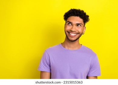 Photo of dreamy cheerful man wear violet t-shirt looking empty space isolated yellow color background - Shutterstock ID 2315015363