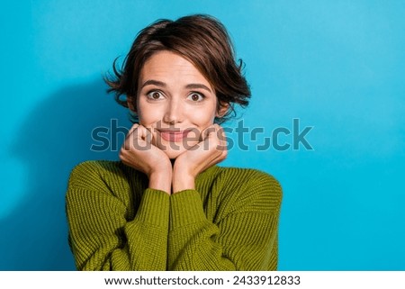 Photo of dreamy cute adorable girl wear trendy green clothes two hands touch face isolated on cyan color background