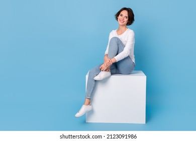 Photo of dreamy cute woman wear white shirt sitting podium chair smiling isolated blue color background - Shutterstock ID 2123091986