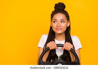 Photo of dreamy happy afro american young woman look empty space drive car isolated on yellow color background