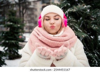 Photo of dreamy lovely girlfriend in white fluffy coat scarf sending you kiss enjoy winter december holidays outdoors - Powered by Shutterstock