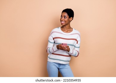 Photo Of Dreamy Pretty Unisex Person Wear Sweater Chatting Gadget Empty Space Isolated Beige Color Background