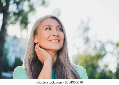 Photo of dreamy thoughtful creative pensioner lady look clear sky wear turquoise t-shirt urban city outside - Powered by Shutterstock