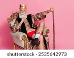 Photo of an eccentric man king lord wear luxurious trendy bathrobe sit throne for casino winners isolated on pink color background