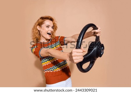 Photo of eccentric woman with foxy hairstyle dressed knit t-shirt hold steering wheel look empty space isolated on pastel color background