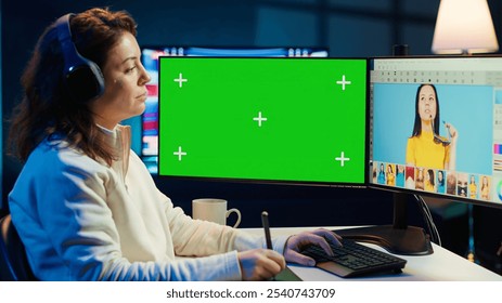 Photo editor using green screen monitor to color correct photographs in creative studio, listening music. Photographer selecting best pictures for editorial content with chroma key computer, camera A - Powered by Shutterstock