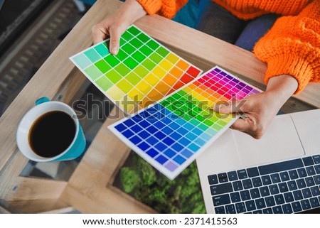 Photo of elderly lady hands arms wear orange pullover holding colors palettes modern device indoors apartment room