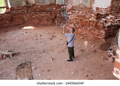 Photo Of An Elderly Man Over 65 In The Ruins Of An Ancient Church

