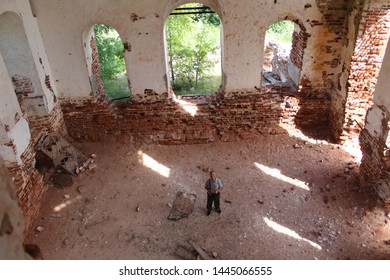 Photo Of An Elderly Man Over 65 In The Ruins Of An Ancient Church

