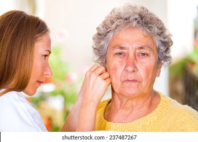 Photo of elderly woman with her carer - Powered by Shutterstock