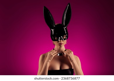 Photo of elegant lady celebrate halooween theme masquerade put off rabbit costume on pink background