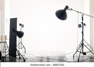 Photo of an empty photographic studio with modern lighting equipment. Empty space for your text or objects.