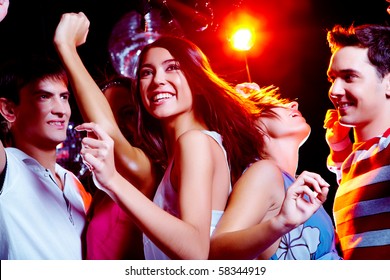 Photo Of Energetic Girl Dancing In The Night Club With Her Friends On Background