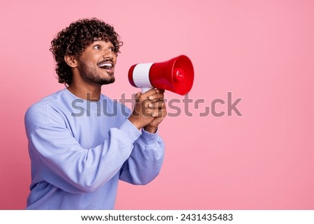 Photo of excited cheerful guy wear trendy clothes hold bullhorn tell say proclaim news isolated on pink color background