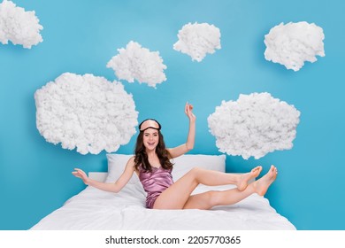 Photo of excited funky lady wear pink pajama sitting cozy soft bed isolated blue color background - Shutterstock ID 2205770365