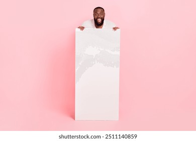 Photo of excited funky young man wear white shirt holding modern device empty space isolated pink color background