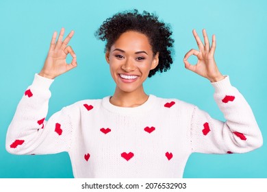 Photo of excited funny african lady dressed white sweater showing two okey signs smiling isolated blue color background