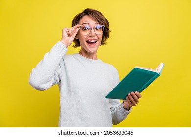 Photo of excited funny nerd lady read book open mouth wear eyewear blue pullover isolated yellow color background - Shutterstock ID 2053633046