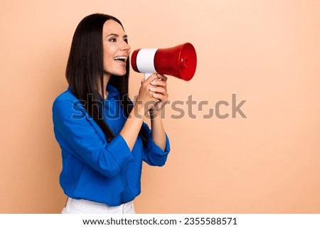 Photo of excited girl professional marketer hold bullhorn look empty space say hurry up special offer isolated on beige color background