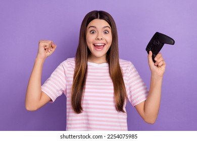 Photo of excited lucky lady wear striped white t-shirt winning playstation game isolated violet color background