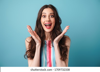 Photo Of Excited Nice Woman In Striped Dress Expressing Surprise At Camera Isolated Over Blue Wall