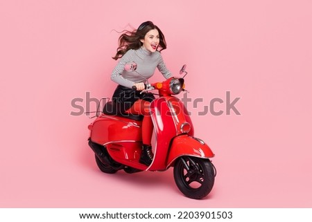 Photo of excited stylish trendy lady ride extreme motor bike wear tights boots isolated pastel color background