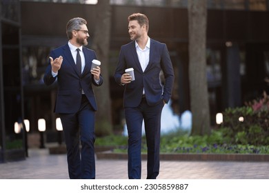 photo of executive discussing business walk with coffee. executive discussing business in the street. - Powered by Shutterstock