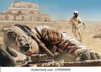 Photo Of A Fallen Wounded Soldier Laying On A Desert Battlefield And Other Soldier Running For Rescue.