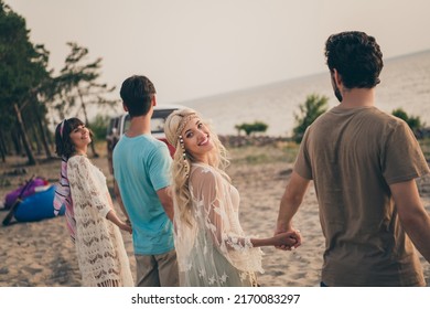 Photo of fellows carefree festive mood hold hands coast sunset wear boho outfit nature seaside beach outside - Powered by Shutterstock