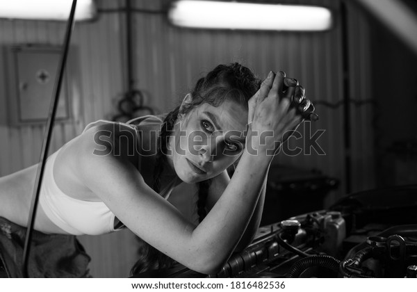 Photo\
of a female car mechanic in a car service\
station