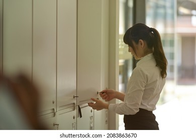 Photo Of A Female Employee Opening Her Locker In The Corporate Office Staff Locker Room.