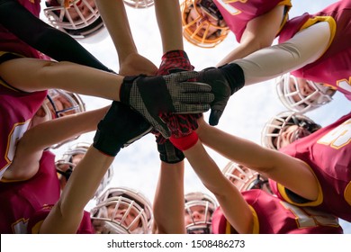 Photo of female rugby players stacking their hands together - Powered by Shutterstock